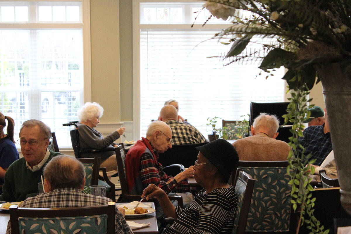 Residents sharing a meal in the sunlit dining room at The Orchard at Stone Creek assisted living, Hahira GA