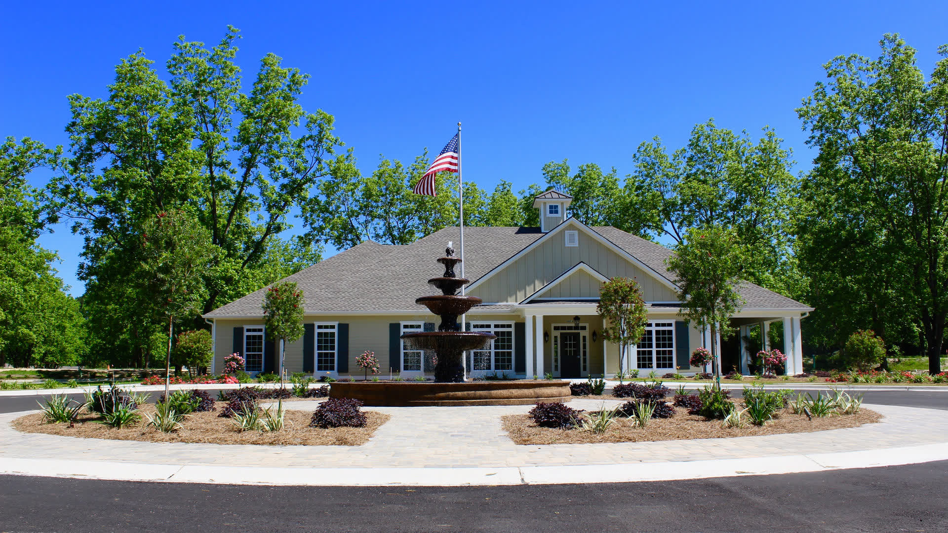 The Orchard at Stone Creek assisted living community clubhouse with fountain and pecan trees, Hahira GA